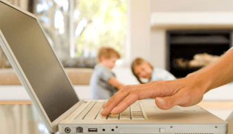 wahm-kids-in-background-typing-on-laptop